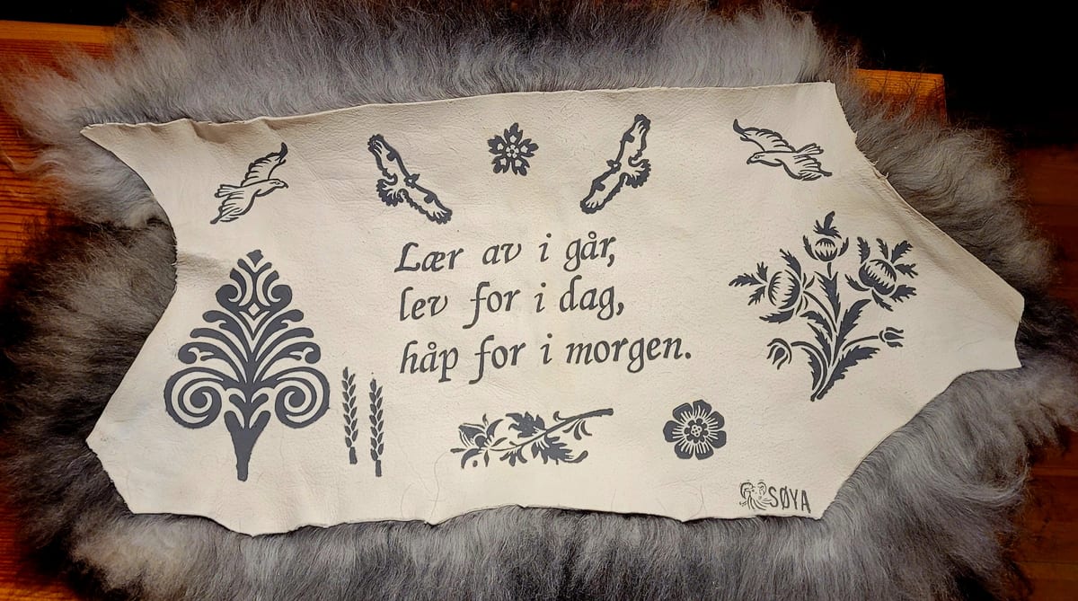 Saueskinn med trykket «Lær av i går, lev for i dag, håp for i morgen»
